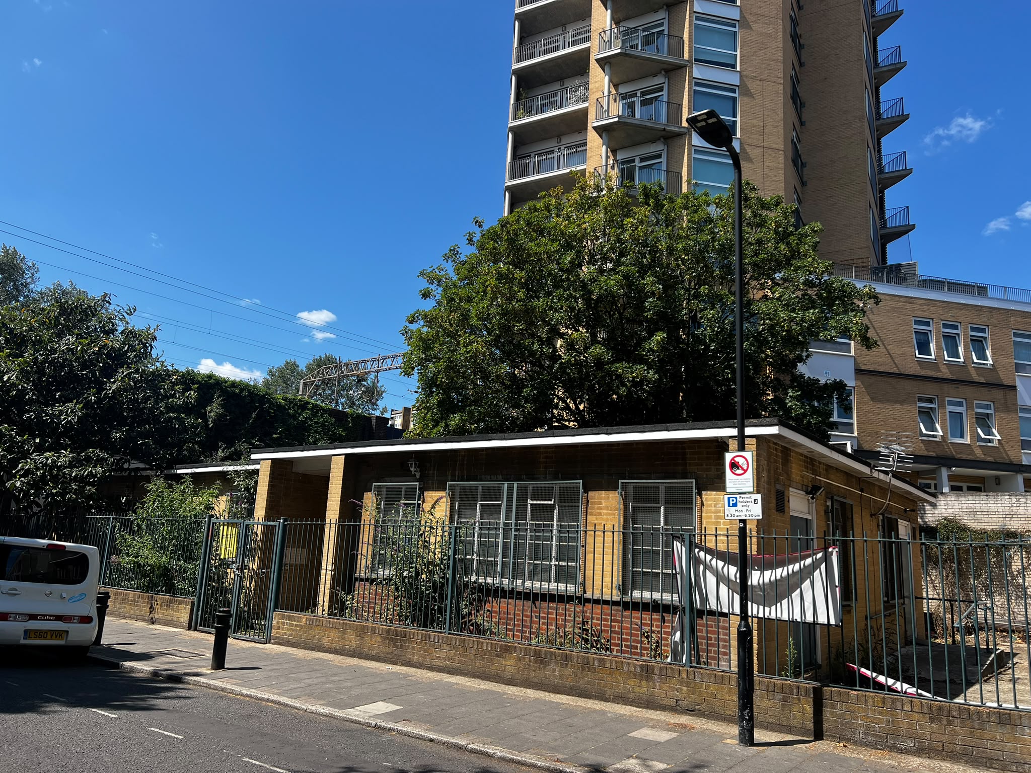 A wide street view of the former Hackney Chinese Community Services building on Ellingfort Road